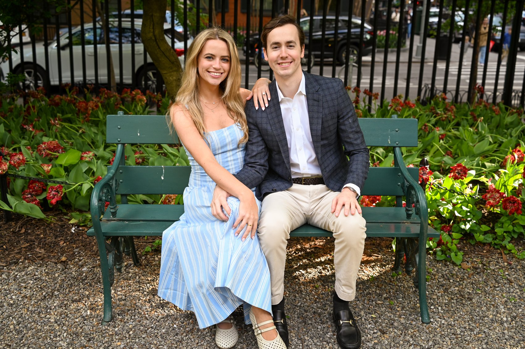 Kaitlin and Nick seated together on a green park bench