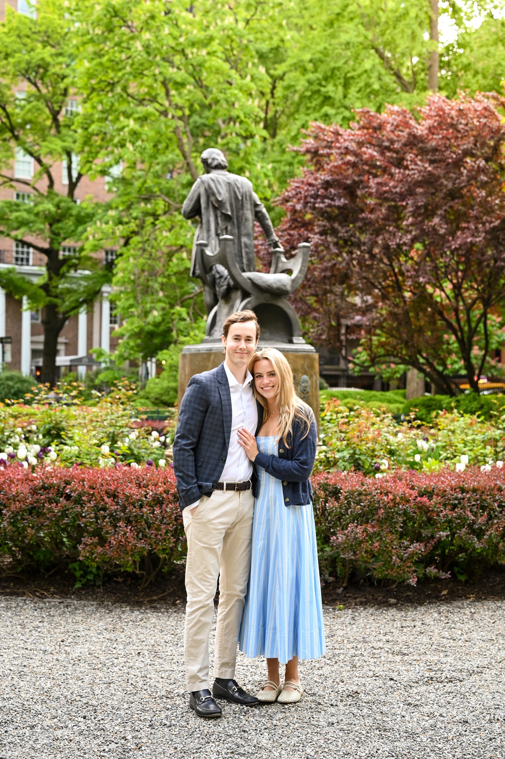 Kaitlin and Nick standing together in front of a bronze statue