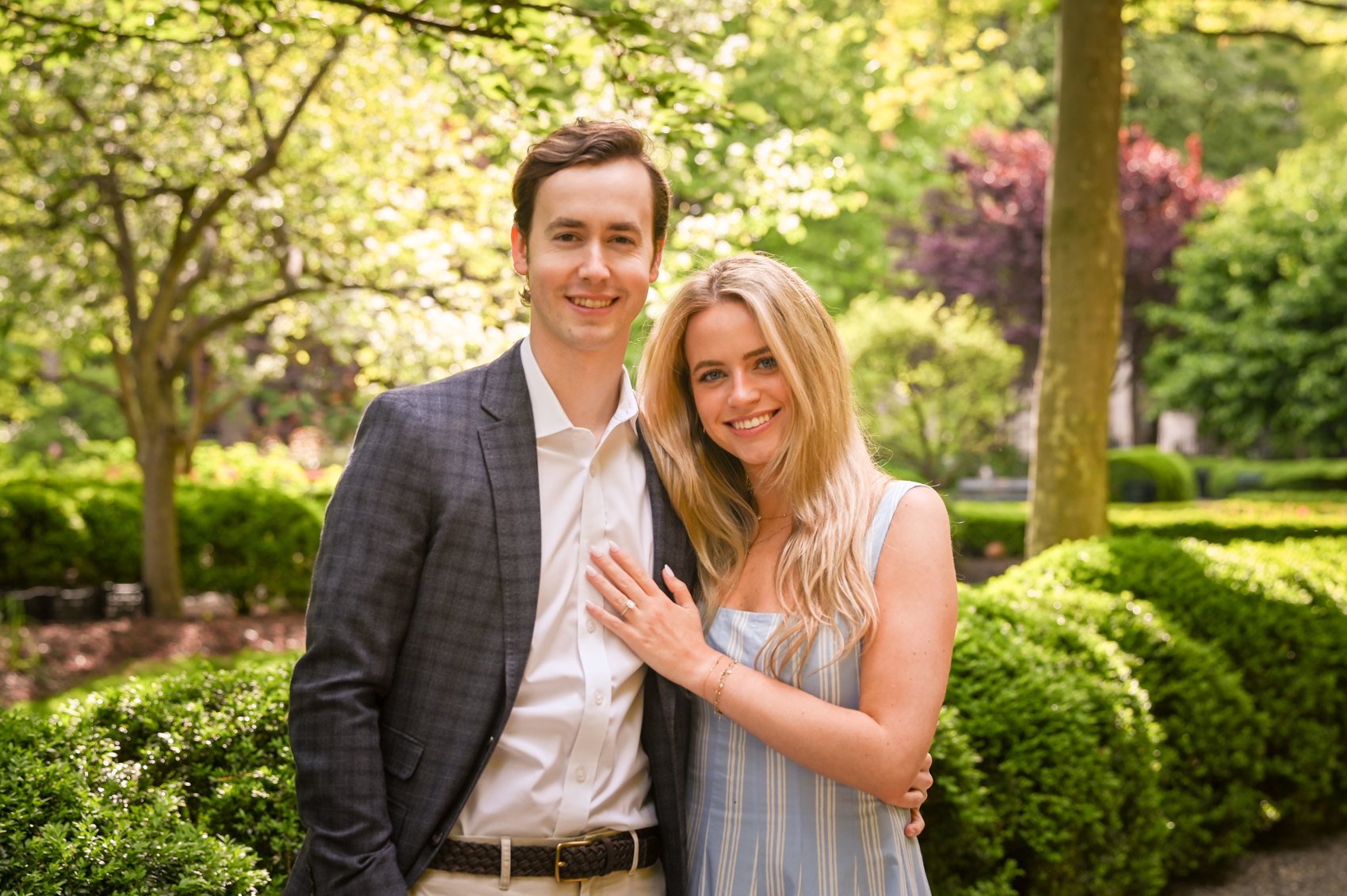 A close standing portrait of Kaitlin and Nick with greenery behind